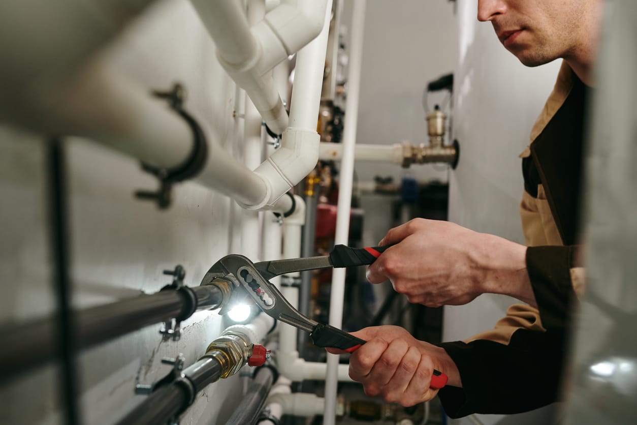 Plumbers maintaining commercial plumbing pipes in Fort Collins