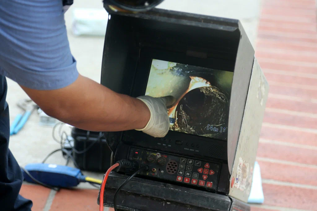 Technician viewing a drain inspection camera in Fort Collins