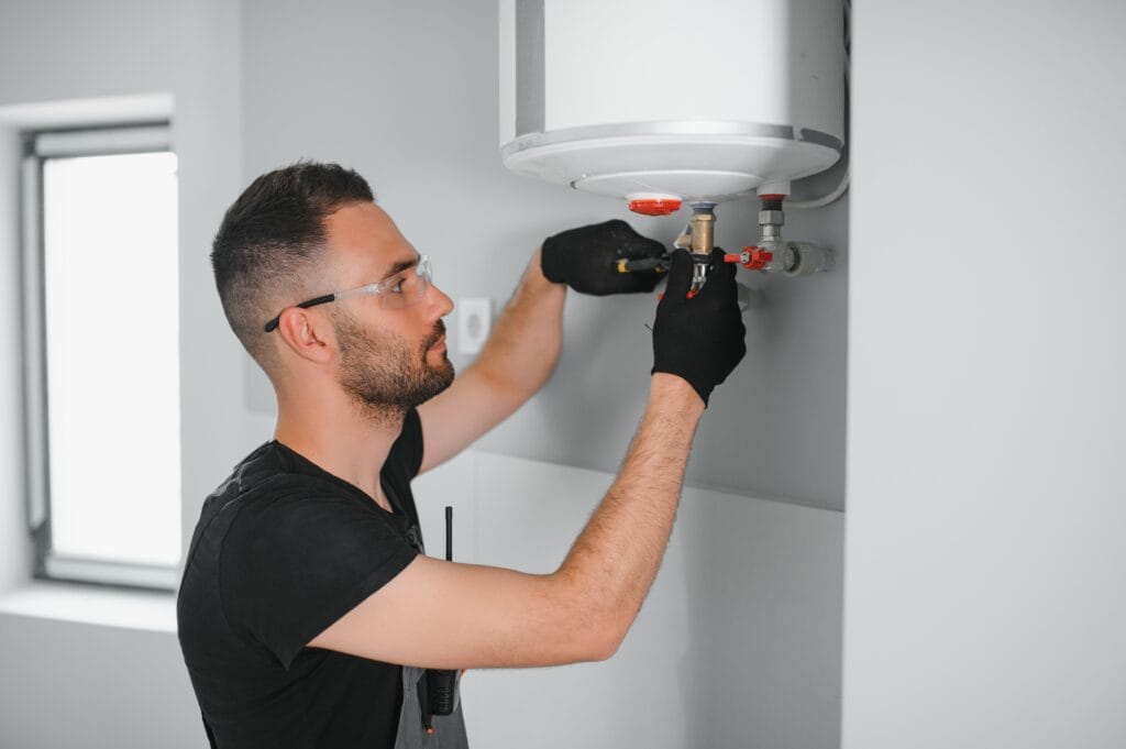 Technician performing water heater maintenance in Fort Collins